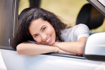 Wall Mural - I love being on the road. Shot of a woman looking cheerful while on a road trip.