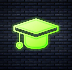 Wall Mural - Glowing neon Graduation cap icon isolated on brick wall background. Graduation hat with tassel icon. Vector