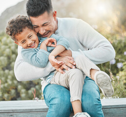 Canvas Print - Love, chaos, and hugs make our family complete. Shot of a father and son having fun outside.