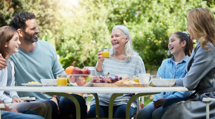 Wall Mural - Family love is never broken. Shot of a family having lunch outside.