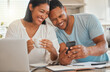 © Kirsten D/peopleimages.com - Looks like our application was approved. Shot of a man showing his wife something on his cellphone while sitting at home.