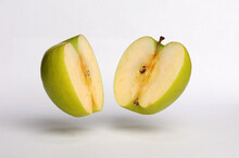 Green Apple Split In Half On A White Background, Hovering