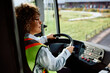 © Drazen - Female bus driver behind steering wheel.