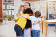 © Nina Lawrenson/peopleimages.com - We love our teacher. Shot of a woman hugging her learners.