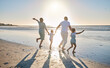 © Kirsten D/peopleimages.com - Come this way for a fun time. Rearview shot of a happy family running towards the sea.