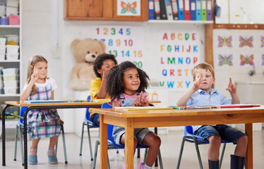 Sticker - With preschool, your child gets a head start. Shot of a group of preschool students sitting in a classroom.