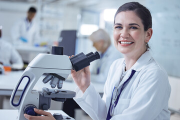 Wall Mural - youll never guess what ive found. shot of a young female lab tech using her microscope.