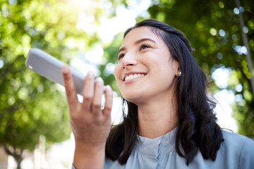 Poster - I have you on speakerphone right now. Low angle shot of a young businesswoman using a cellphone in the city.