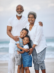 Sticker - Our loving legacy. Shot of a mature couple bonding with their grandkids at the beach.