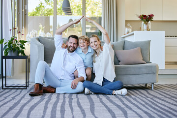 Poster - Well always keep a roof over their heads. Full length portrait of an affectionate family of four gesturing as if they have a roof over their heads while sitting in the living room at home.