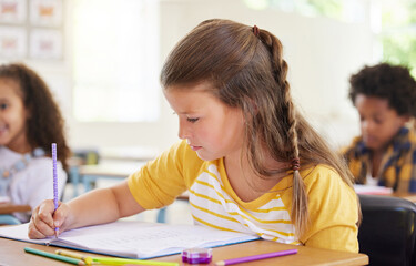 Sticker - Colouring is the perfect time to practice naming the colours. Shot of a preschooler colouring in class.