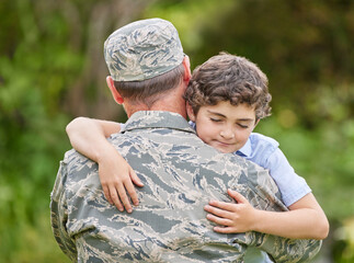 Wall Mural - A family is a group of people who love unconditionally. Shot of a father returning from the army hugging his son outside.