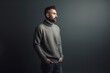 © Anne-Marie Albrecht - handsome bearded man in grey sweater looking away isolated on grey background