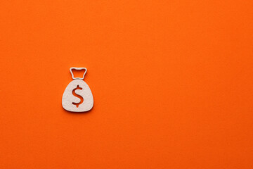 White money bag on orange color background - money bag icon with a dollar sign, graphic resource for design