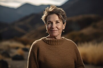 Wall Mural - Portrait of a senior woman with short hair in the mountains.