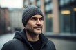 Group portrait photography of a satisfied man in his 30s wearing a warm beanie or knit hat against a modern architectural background. Generative AI