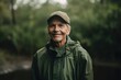 © Eber Braun - Portrait of smiling senior man in raincoat and cap standing outdoors