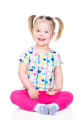 happy little girl with downs syndrom looks at camera. isolated on white background