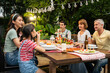 © Kawee - Multi-ethnic big family having fun, enjoy party outdoors in the garden.