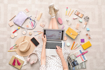 Poster - Woman with laptop, makeup products and accessories shopping online on beige carpet