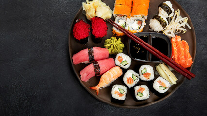 Wall Mural - Traditional Japanese food dishes on black background, top view, copy space