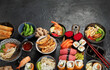 Traditional Japanese food dishes on black background, top view, copy space