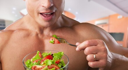 Poster - Happy young sporty man eating a bowl of fresh salad