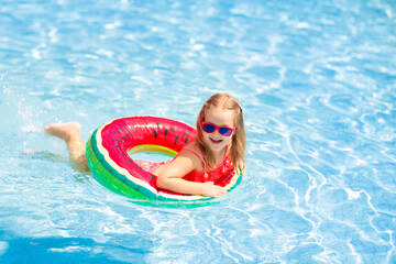 Wall Mural - Child in swimming pool. Kids swim. Water play.