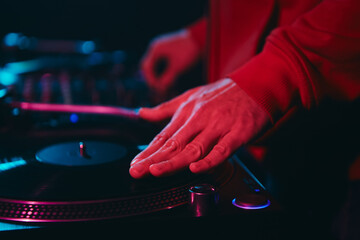 Sticker - Hip hop dj scratching vinyl disc with music on deck. Club disc jockey scratches a record on turntable player