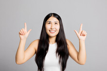 Portrait Of Adorable Delighetd Woman Pointing Index Finger Herself Impressed She Choose News Wear Good Look White Asic Casua T-shirt Isolated Over Grey Background Looking Up Curiously.
