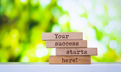 Wooden blocks with words 'Your success starts here'.