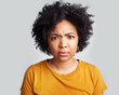 © N Felix/peopleimages.com - Confused, portrait and woman in studio, pensive and unsure against a grey background. Doubt, annoyed and face of African female with dont know frown, attitude and angry, doubtful and frustrated