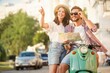 © opolja - Young couple traveling, reading map in the city
