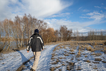 Wall Mural - Man walking on snow-covered ground and melting hoar frost, Twizel, South Island