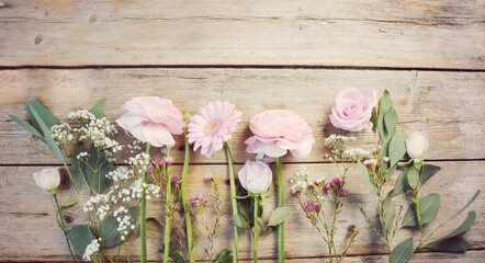 Wall Mural - Beautiful bouquet of pink flowers on rustic wooden board - Background for mothers day, wedding or birthday - floral gift greeting card