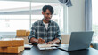 © NanSan - Mixed race Asian indian ethnicity young man chinese transport shipment delivery service sme parcel cardboard box package on delivery small business owner SME, shopping online