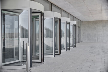 Revolving doors. The facade of a modern shopping center or station, an airport with revolving doors.