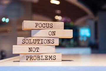 Wooden blocks with words 'Focus on solutions, not problems'. Inspirational motivational quote