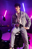 Fototapeta Nowy Jork - 80s sytle young man on scooter with purple background