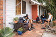 © Austockphoto - Aboriginal family sitting together on back porch