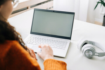 Remote Learning with Laptop: Woman Student Viewing Blank Screen Mockup for E-Learning Website, Online Education and Working Remotely