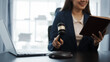© Phushutter - Portrait of female asian lawyer manager in formal suit working with signed insurance contract law, legal, legislation, online consulting real estate clients close deal in realtor office.