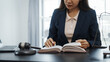 © Phushutter - Portrait of female asian lawyer manager in formal suit working with signed insurance contract law, legal, legislation, online consulting real estate clients close deal in realtor office.