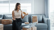 © Phushutter - Using laptop, Portrait of pretty asian sme freelancer woman checking customer paid order on sofa after packing into cardboard box, online home small business, online influencer asia people.