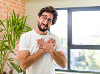 Wall Mural - young adult crazy man with expressive pose at a modern house interior