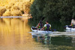 © .shock - A group of friends enjoying having fun and kayaking while exploring the calm river, surrounding forest and large natural river canyons