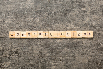 congratulations word written on wood block. congratulations text on cement table for your desing, concept
