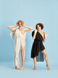 © master1305 - Two beautiful women in image of angel and demon against blue background. Plastic surgery and injections against natural look. Concept of natural and fake beauty, cosmetology, choice, conflict of being