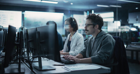 Fototapete - Diverse Young Colleagues Working on Computers in a Research Laboratory. Female Asking Advice from a Male Software Developer Colleague About a Solution for Their Collaborative Industrial Tech Project