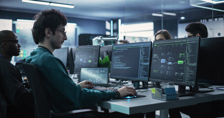 Team of Talented Young Professionals Working in a Technological Research and Development Agency. Computer Screens with Software Code, Customer Relationship Management Tool and Road Map User Interface